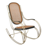 Modernist rocking chair in gilded brass and cane.