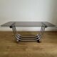 Smoked glass coffee table and chrome base by Yves Boutboul