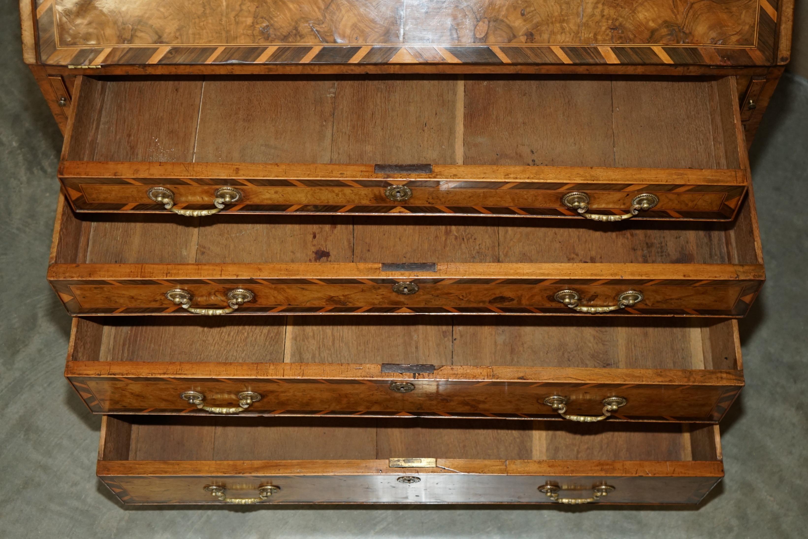 Antique George II bureau from 1740 in walnut, rosewood, and leather.