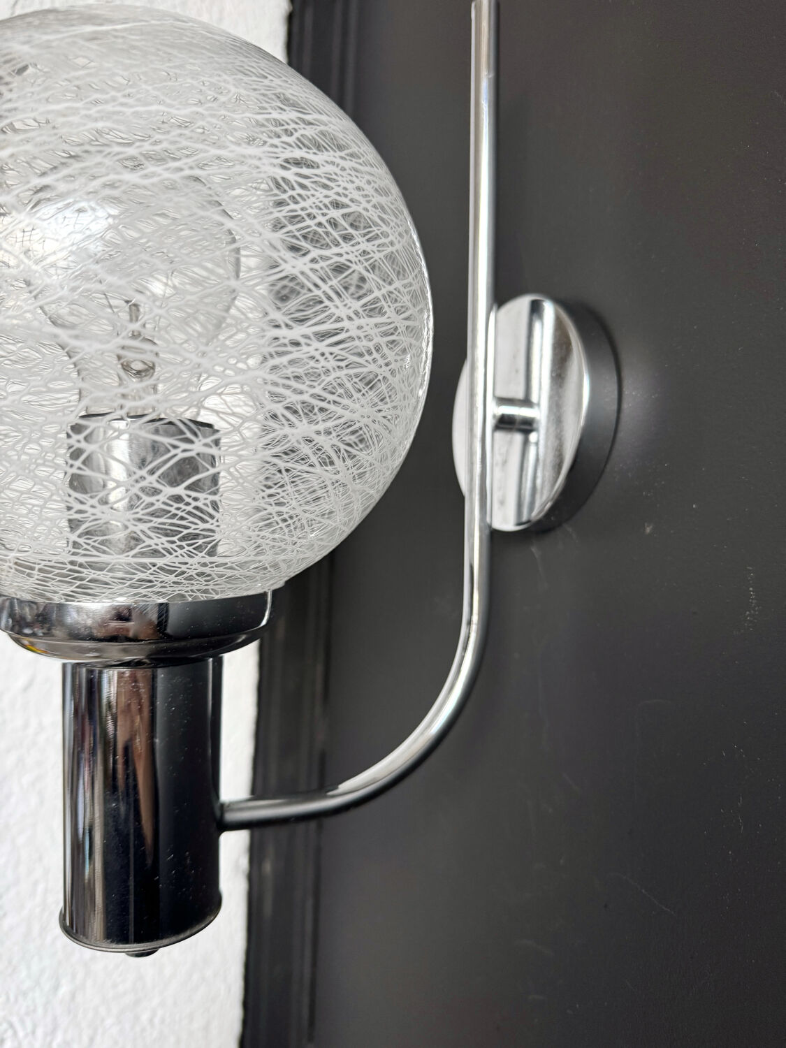 Chrome wall light with blown glass from the 1970s.