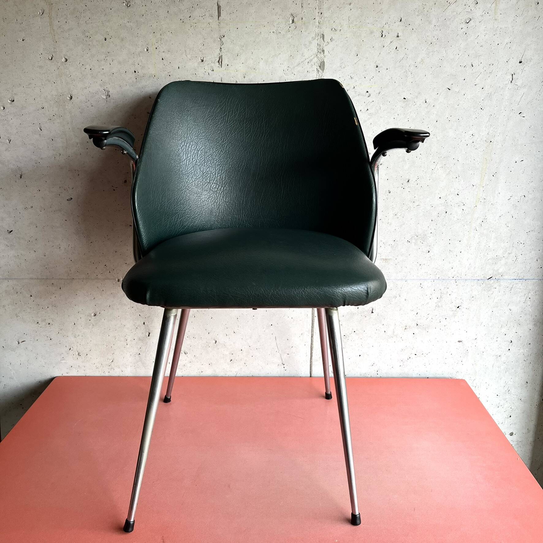 Vintage green faux leather and chrome armchair