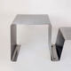 Stainless steel coffee table and stool, by the Roche Bobois design office, 1970