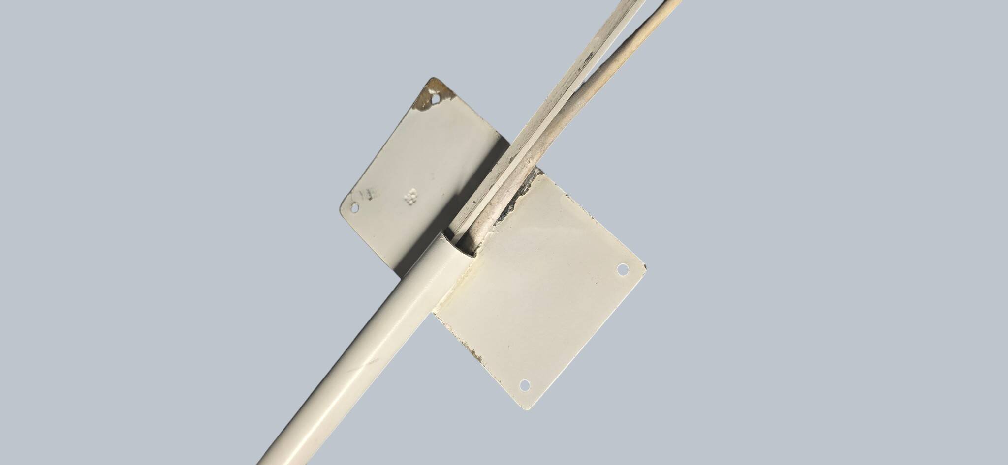 Minimalist metal wall light in the style of Jean Prouvé, circa 1950.