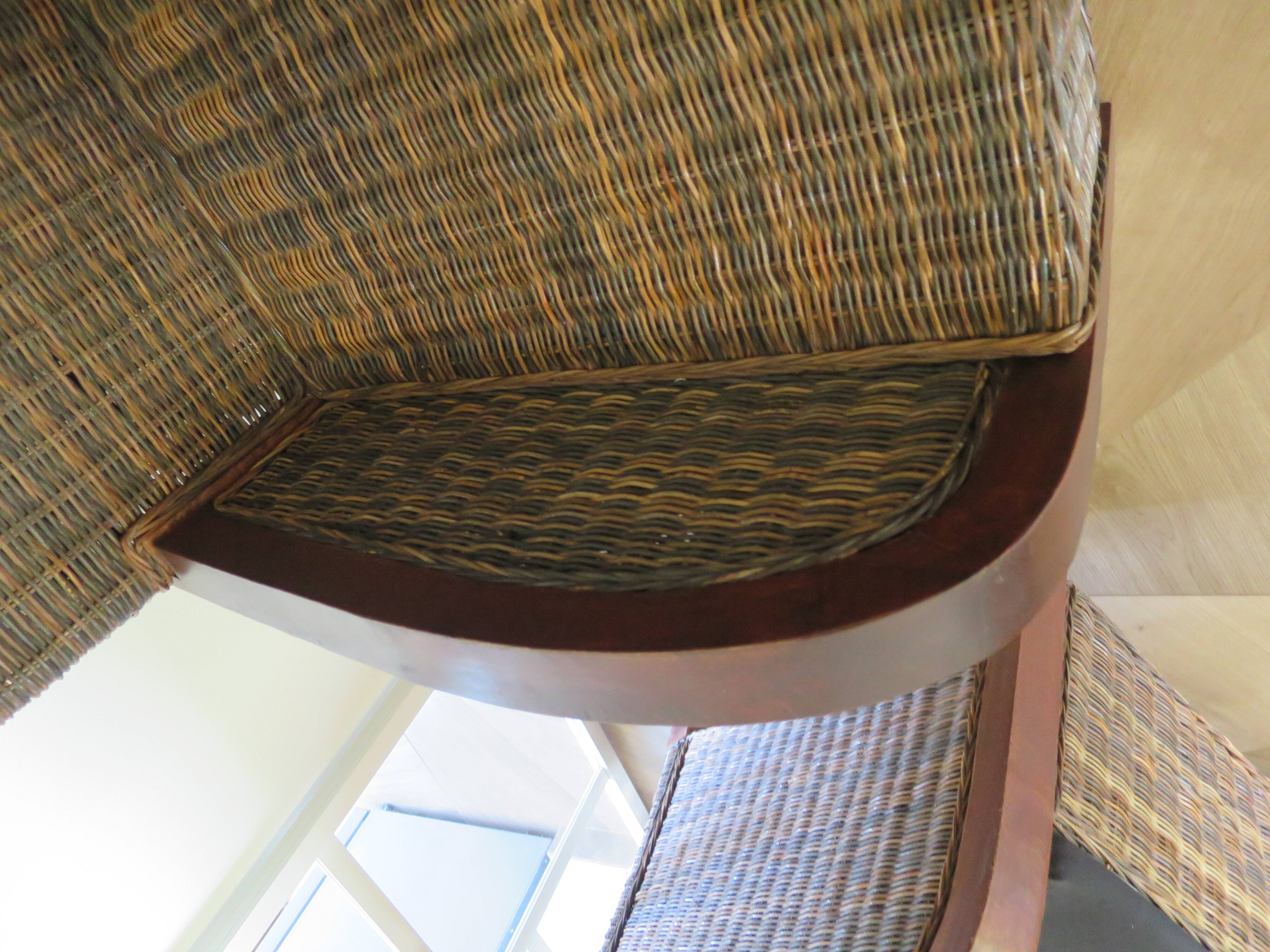 2 colonial-style armchairs in woven rattan and exotic wood