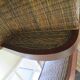 2 colonial-style armchairs in woven rattan and exotic wood