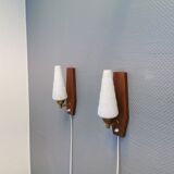 Danish wall lights from the 1970s, made of milky white glass shades, teak wood suspension and brass.