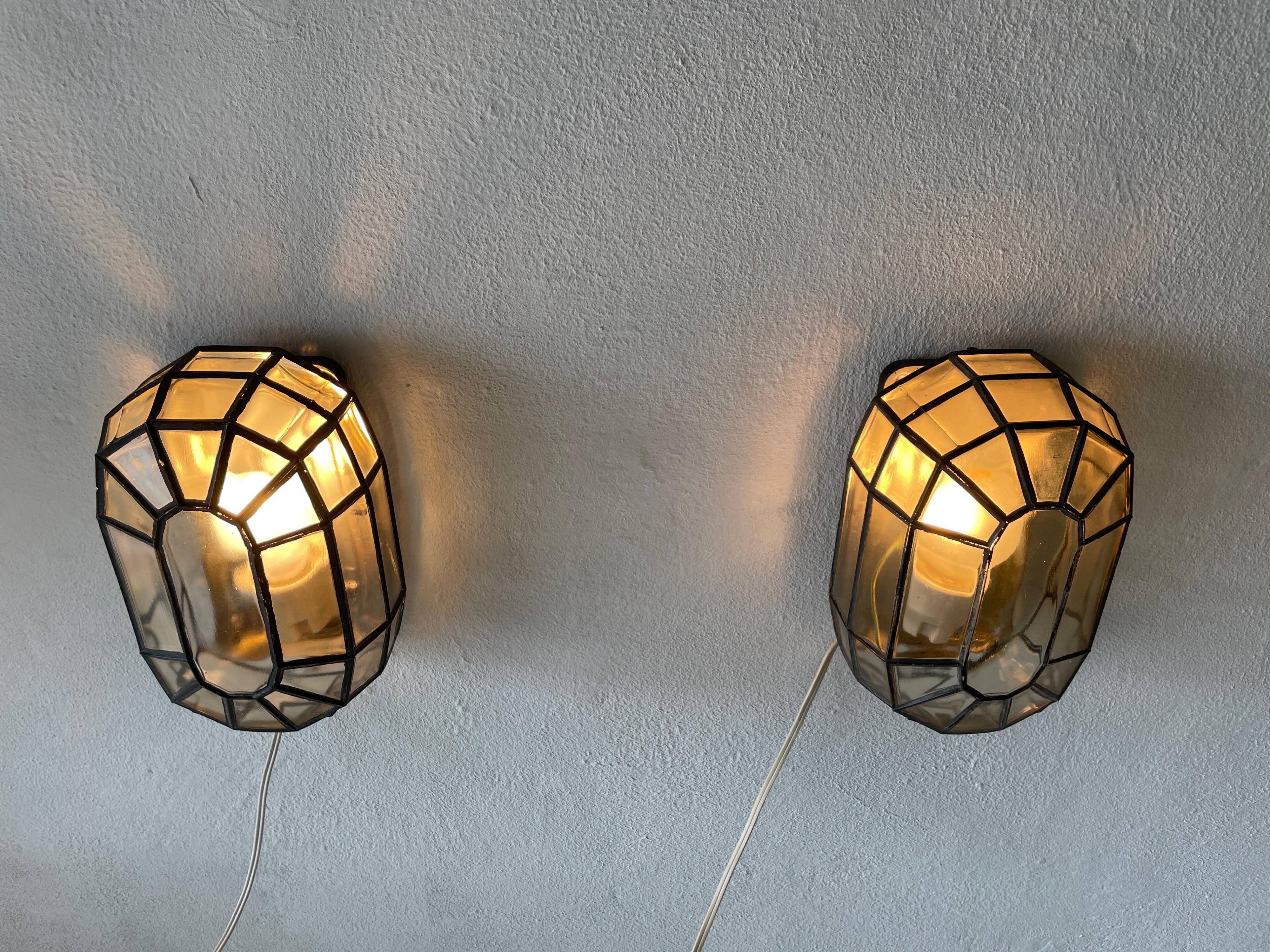 Pair of black iron wall sconces with structured glass by Limburg, 1960s, Germany.
