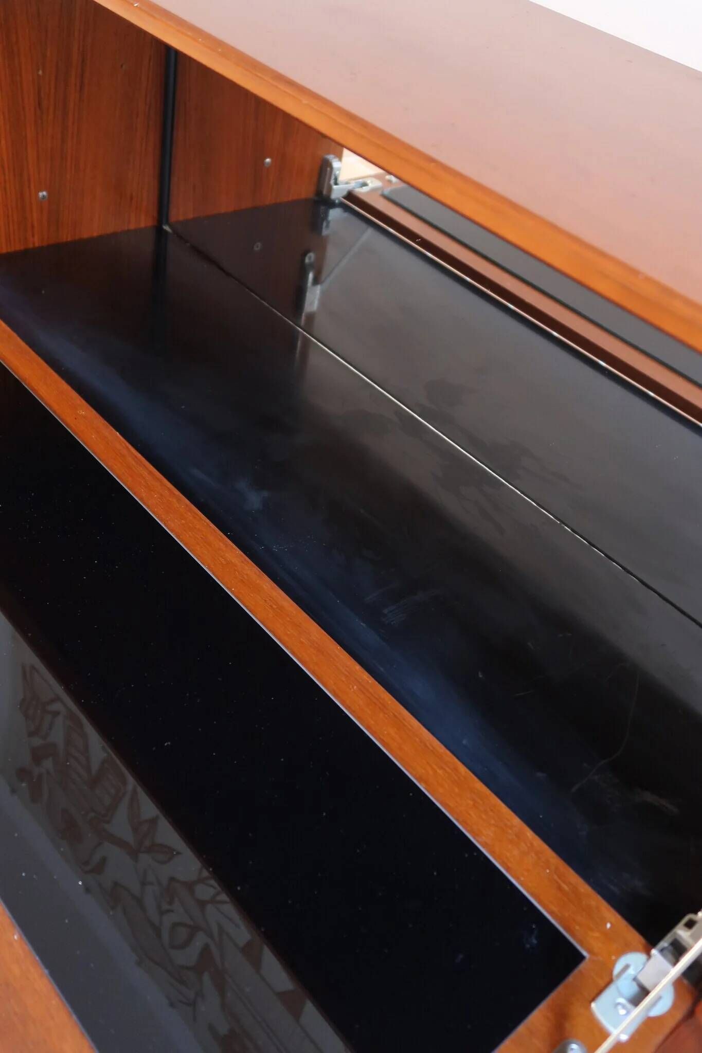 Vintage teak bar cabinet with black glass interior.