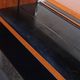 Vintage teak bar cabinet with black glass interior.