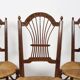 3 wooden and straw chairs, decorated with a sheaf of wheat.