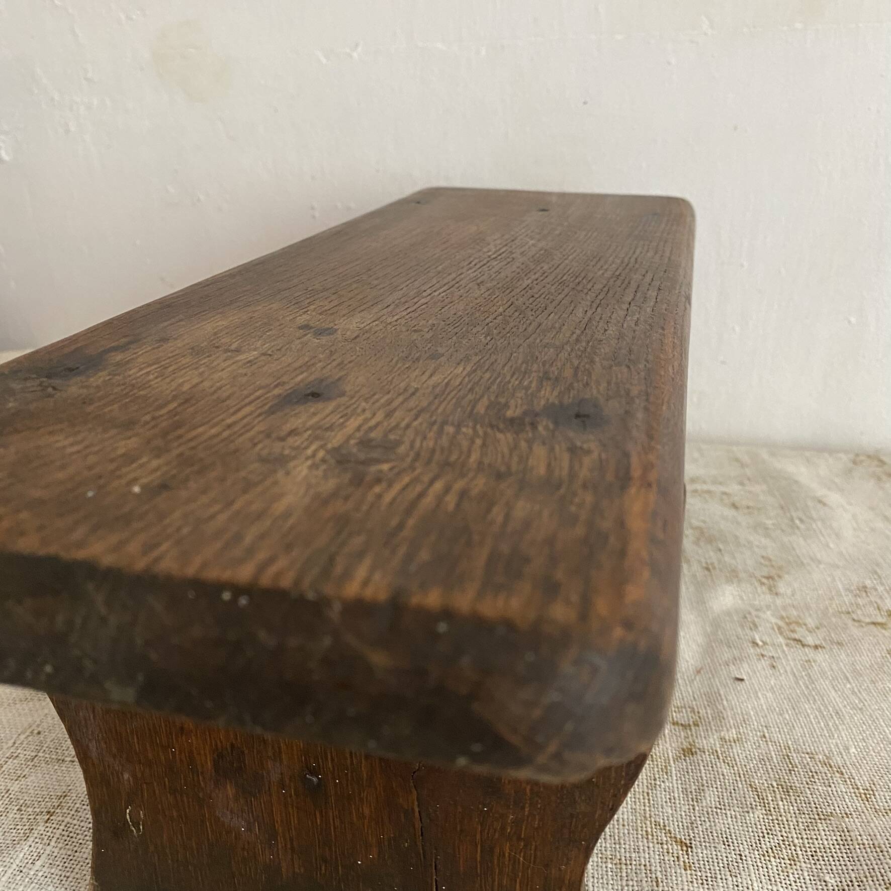 Old low stool made of solid wood