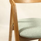 Vintage dining chair in light oak with natural linen pastel green fabric.