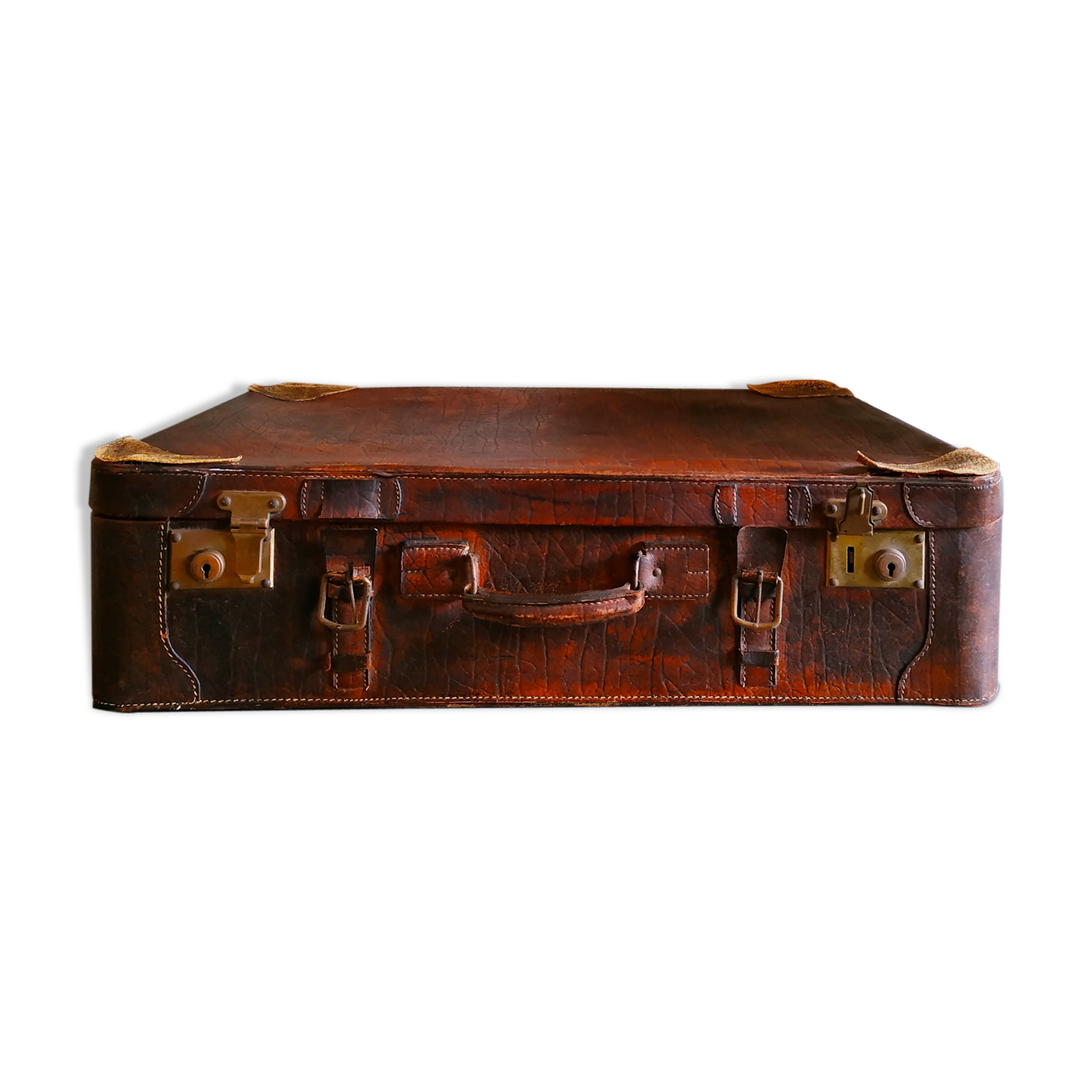Old cardboard suitcase covered with patinated leather
