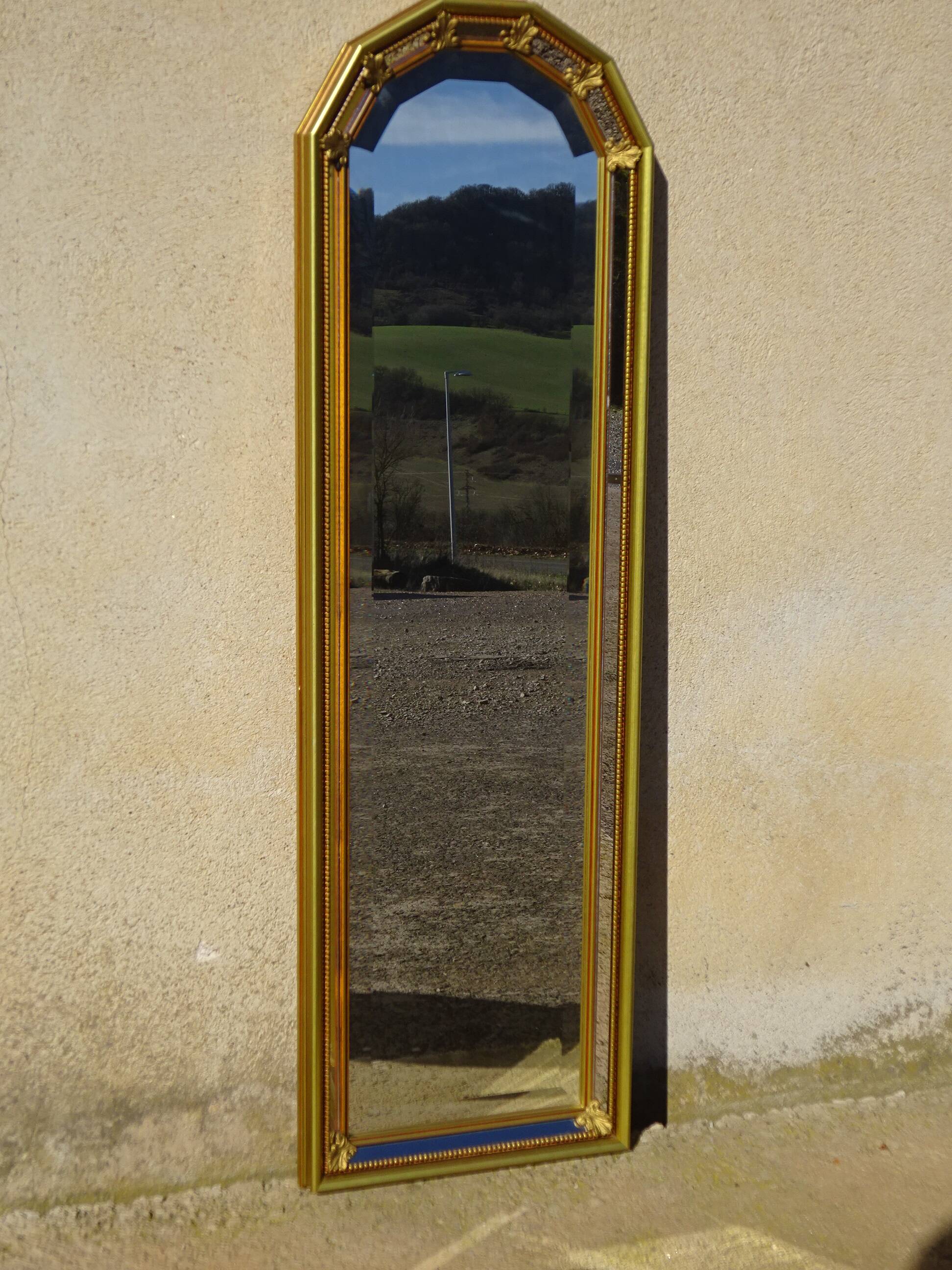 Hall mirror, gilded frame with fillets and fleur-de-lis.
