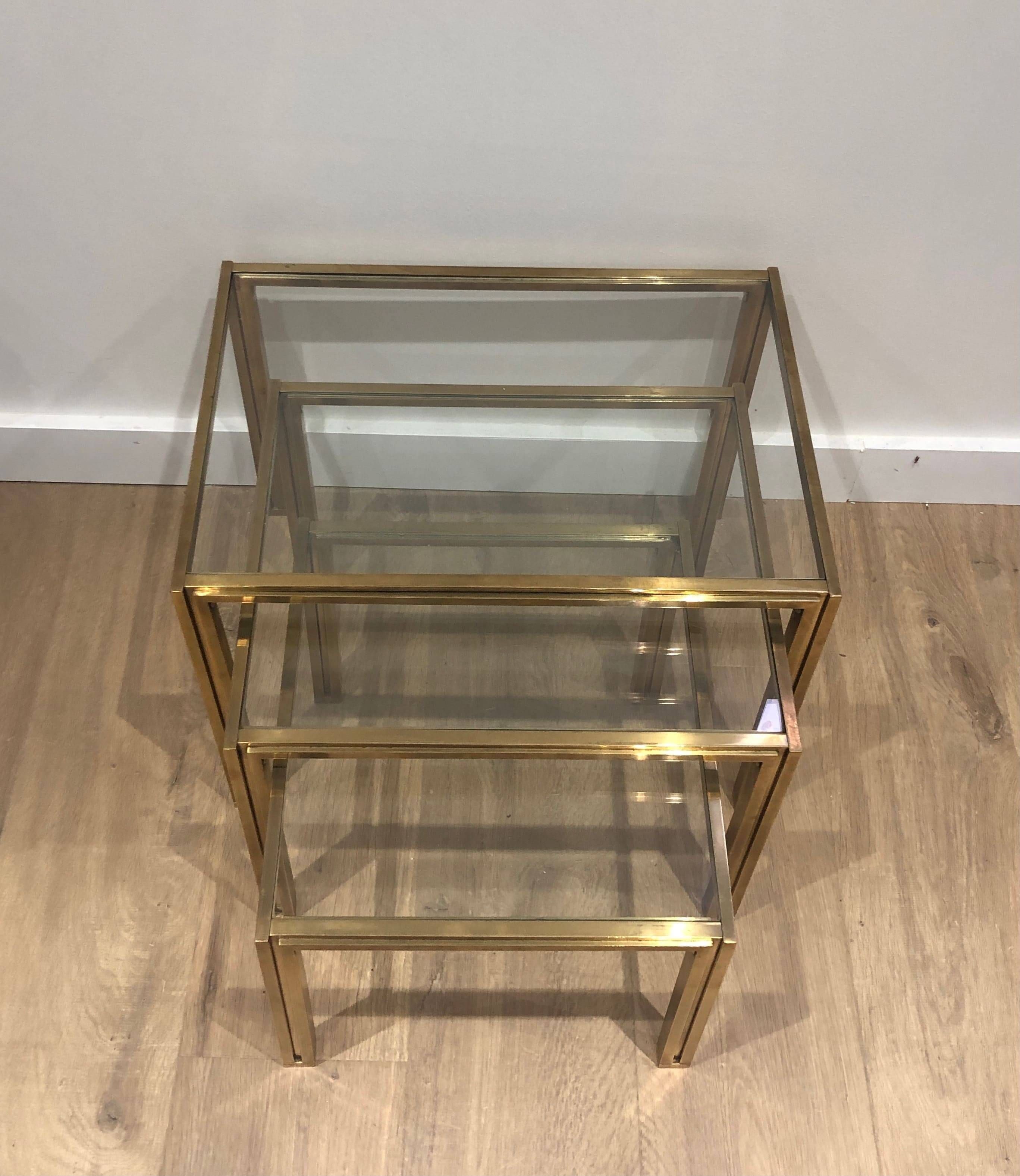 Set of 3 nesting tables in brass and glass. French work by Guy Lef.