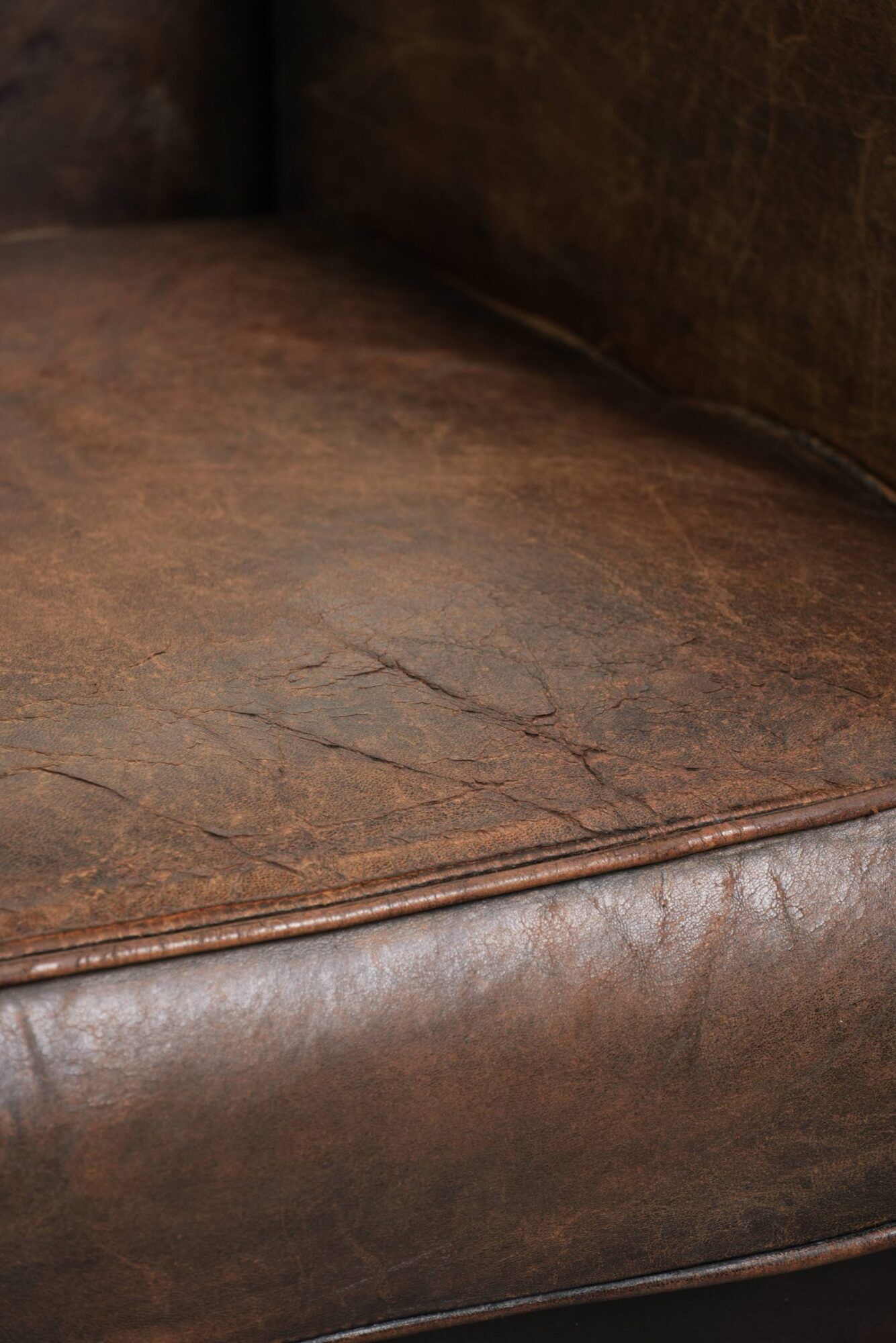 Comfortable sheepskin armchair with matching piping and a timeless look