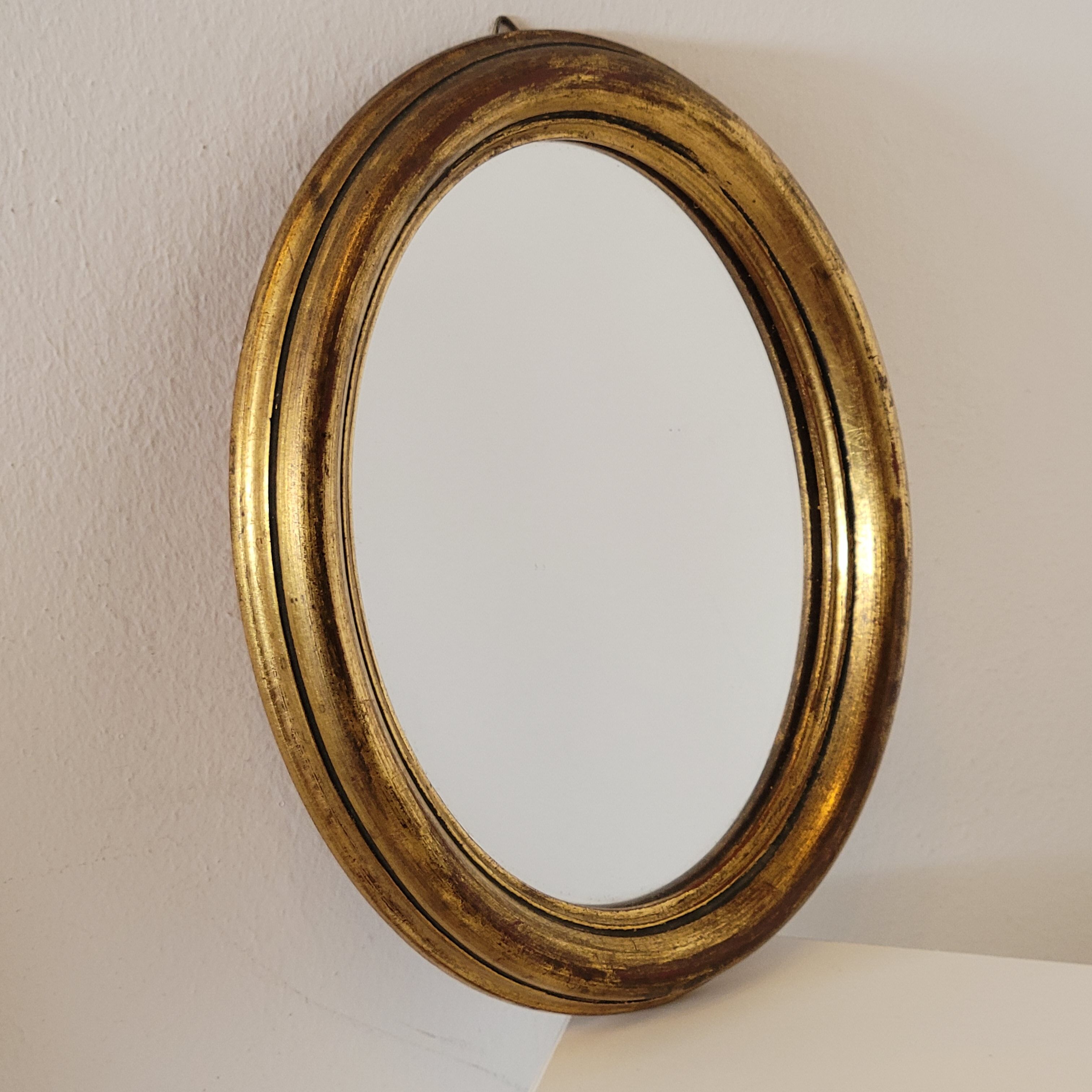 Old small oval mirror gilded wooden frame 22 X 17 X 2 cm.