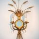 A pair of 1950s wall sconces in gold leaf metal.