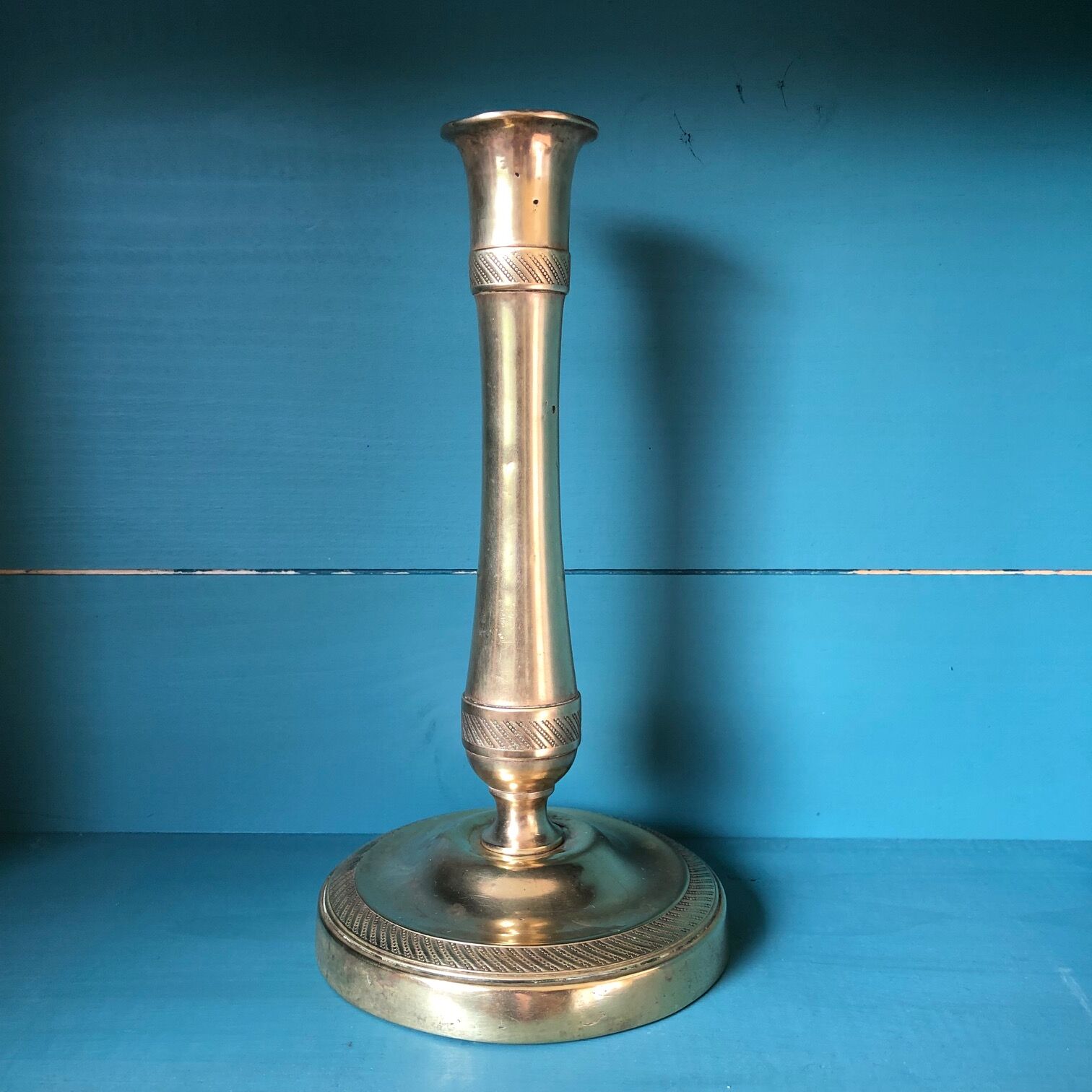 Large candlestick in chiseled brass