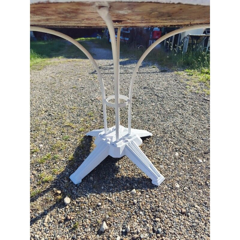 Garden table with a cast iron base and a metal top.