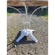 Garden table with a cast iron base and a metal top.
