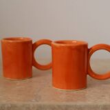 Handmade orange peach ceramic coffee mug set with large circular handles