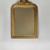 Golden mirror with a pediment from the early 20th century.