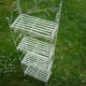 Folding white wrought iron shelf