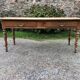 Antique Louis Philippe style farm table in solid cherry wood with 2 drawers and turned base.