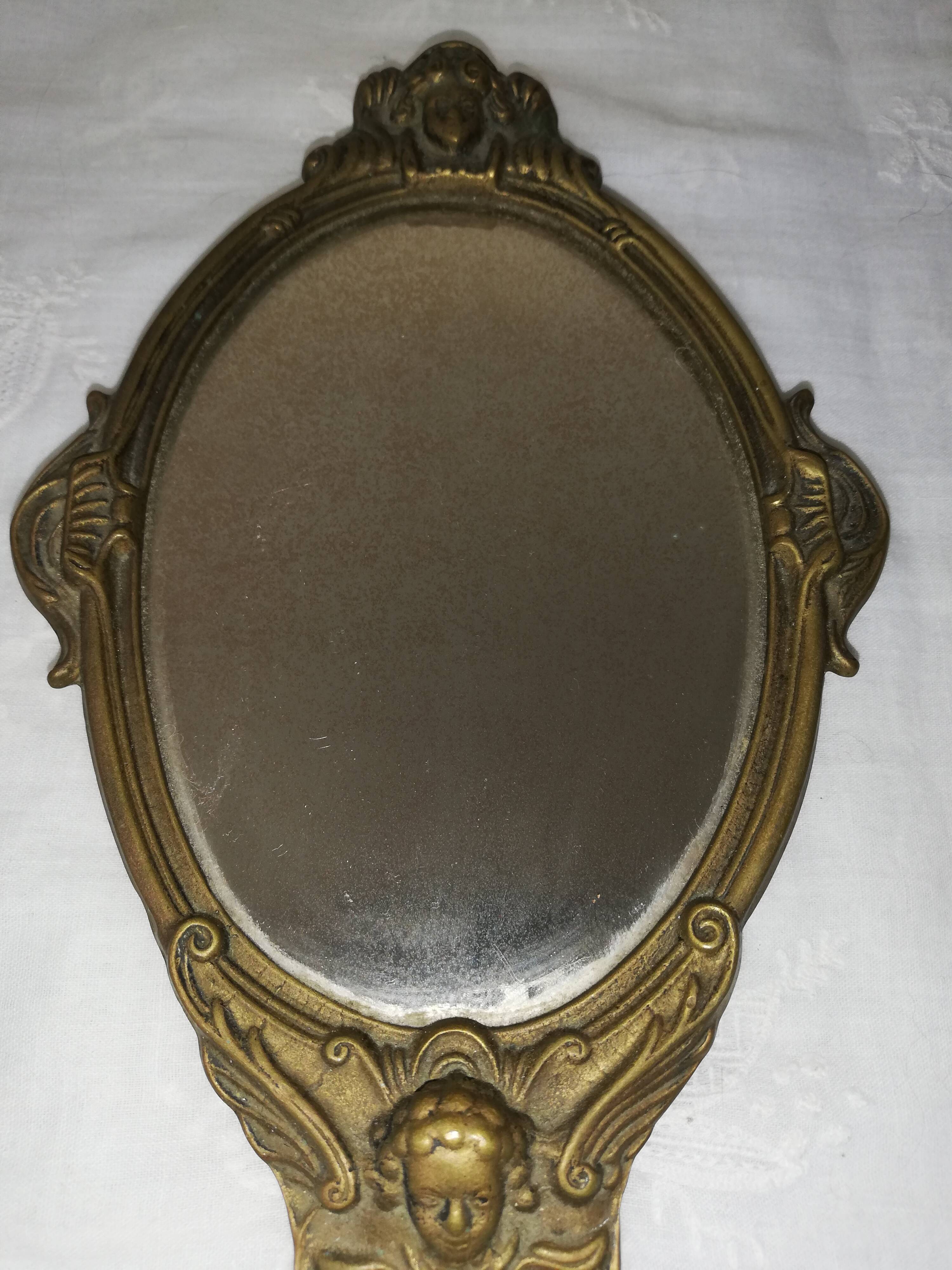 Old hand-facing mirror in gilded bronze