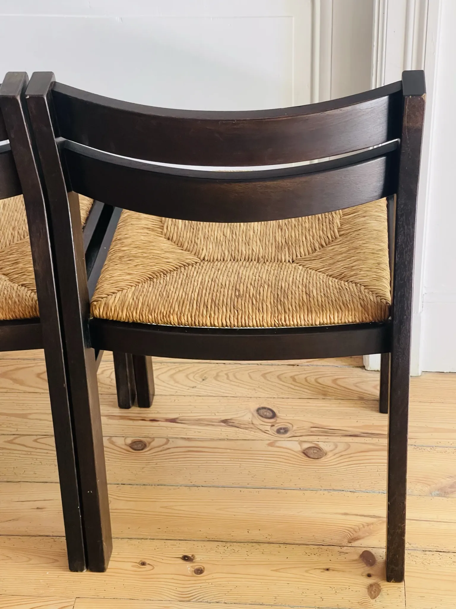 Pair of straw-seated wooden chairs in the regain style.