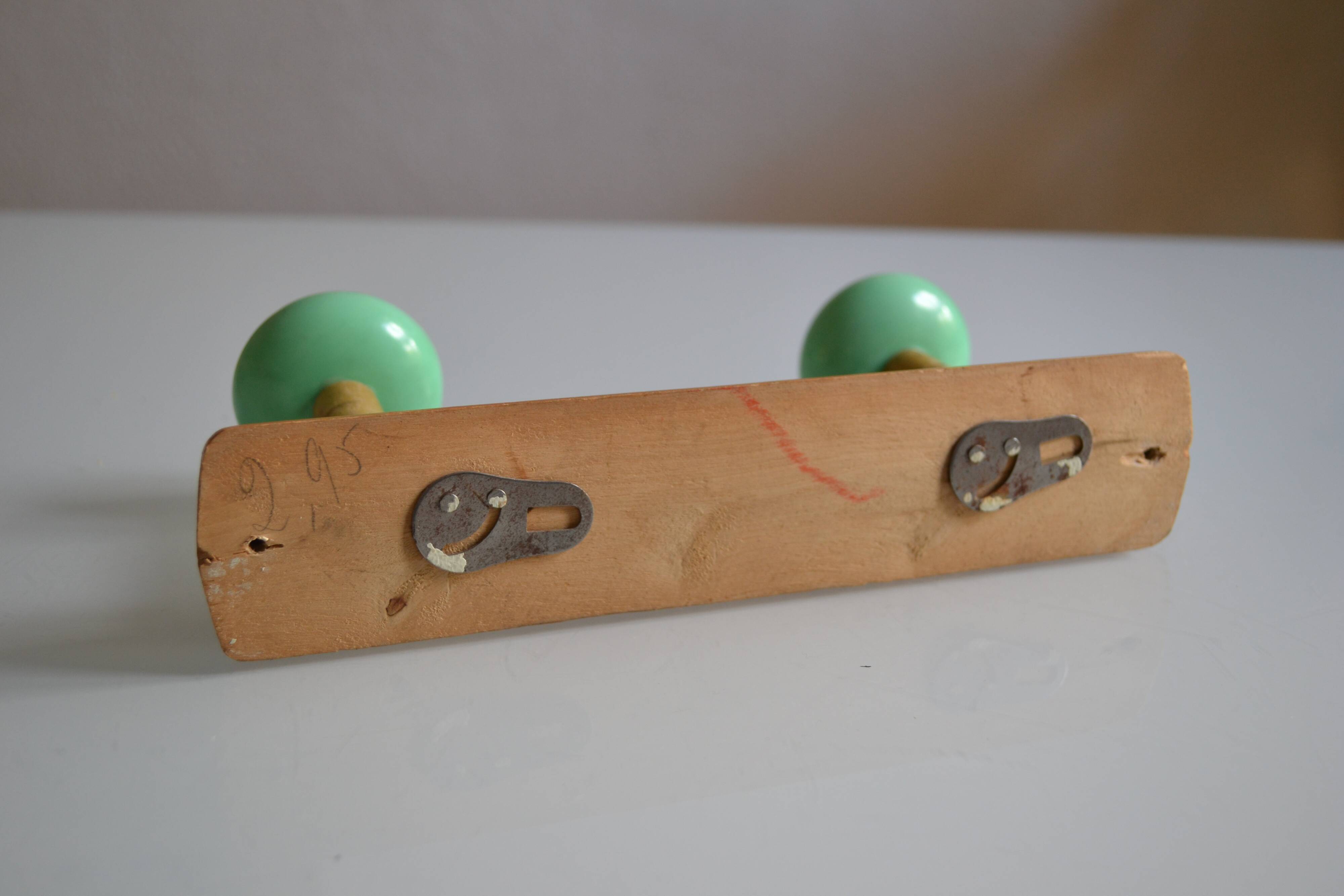 Wall coat rack with 2 hooks, wood and plastic, 60s style.