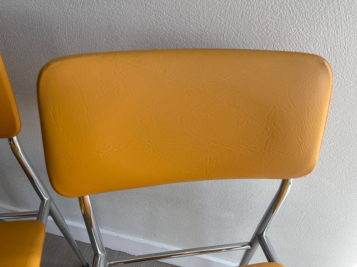LM vintage chrome and orange/mustard yellow faux leather chairs