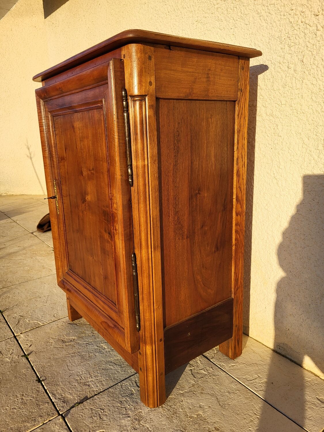 Furniture with a cherry wood door.