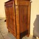 Furniture with a cherry wood door.