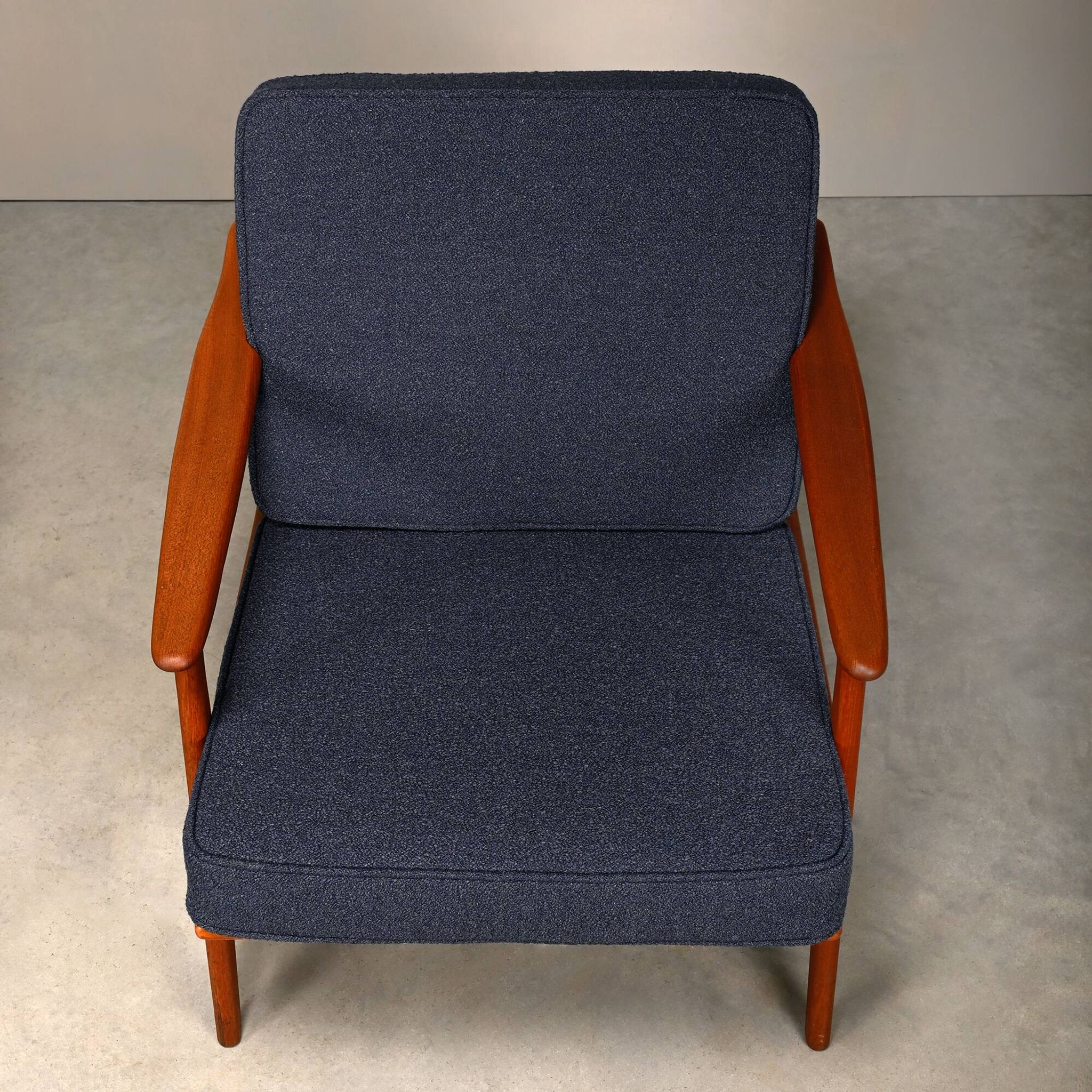 Pair Scandinavian Modern armchairs in teak and dark blue bouclé fabric