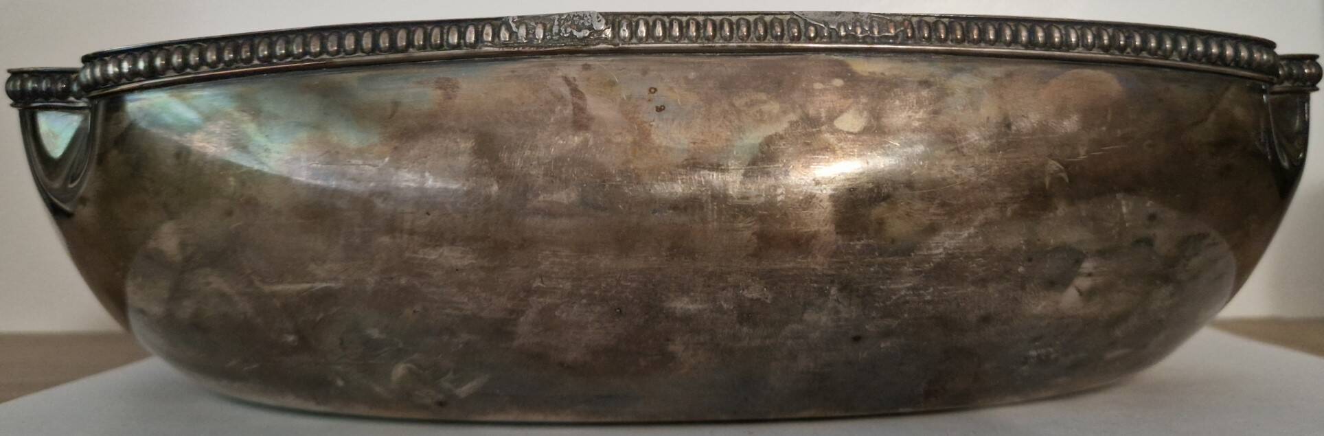 I037 Large shallow antique silver-plated dish in the Louis XVI style with bead decoration.