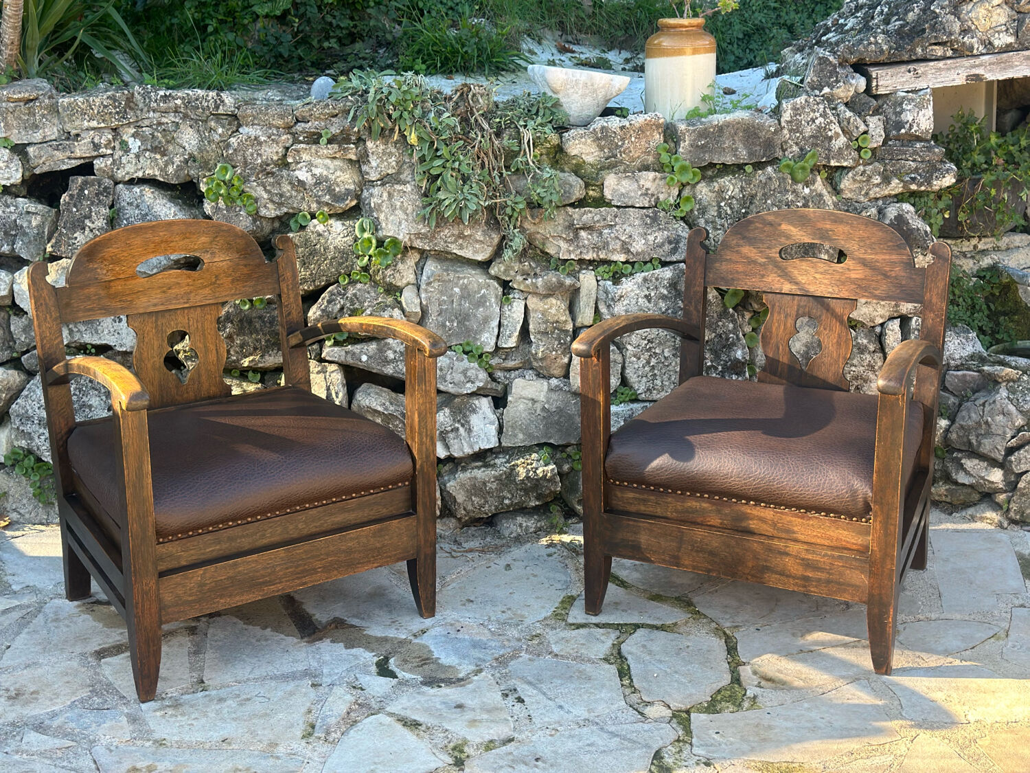 Pair of armchairs in stained wood and leather, 20th century