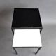 Pair of modernist nesting tables in black metal and white and black opaline 1960.
