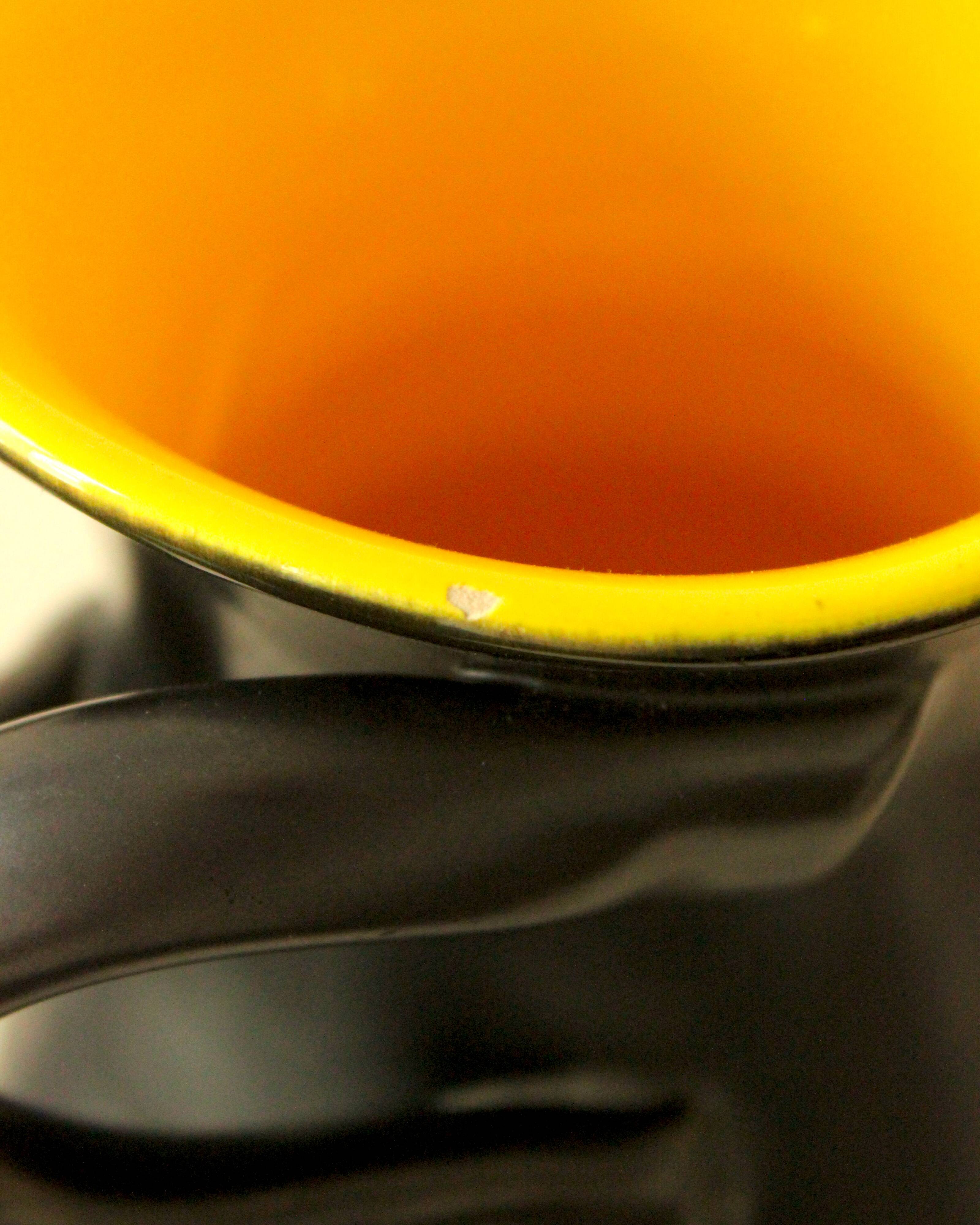 Glazed ceramic vase in black and yellow, in the style of Pol Chambost.