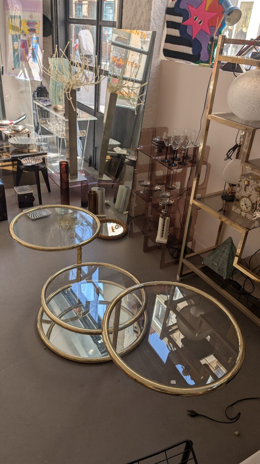 Gold brass coffee table with rotating trays.