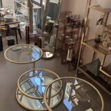 Gold brass coffee table with rotating trays.