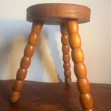 Round tripod stool in carved wood