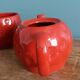 Teapot and cup in the shape of a strawberry.