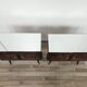 Mid-century mahogany bedside tables with mirrored tops.