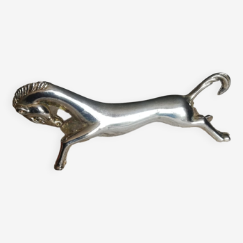 A silver metal horse knife holder