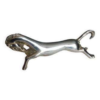 A silver metal horse knife holder