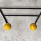 Two vintage metal and wood ball coat racks