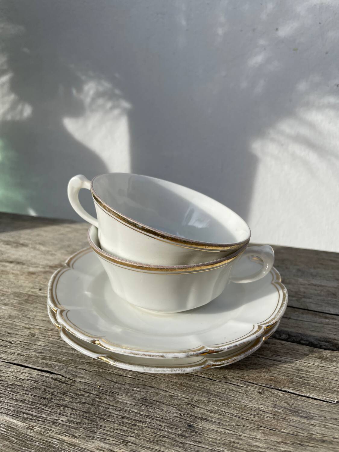 Pair of fine white and gold Limoges porcelain teacups