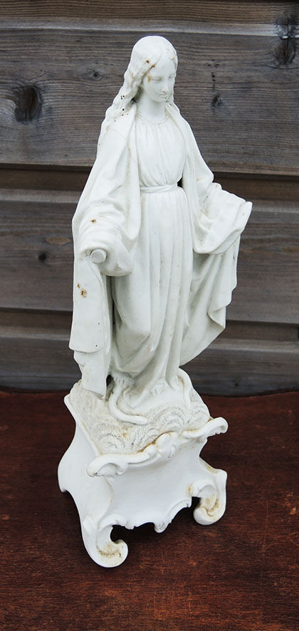 Ancient statuette of the virgin with the serpent in biscuit